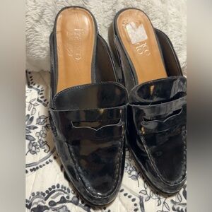 black patent leather Franco Sarto penny loafer mules.